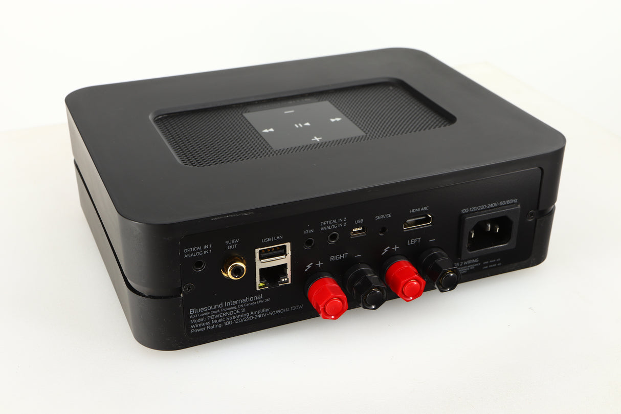 Close up of a used Bluesound Powernode 2i Streaming Amplifier in a black finish showing marking on the rear