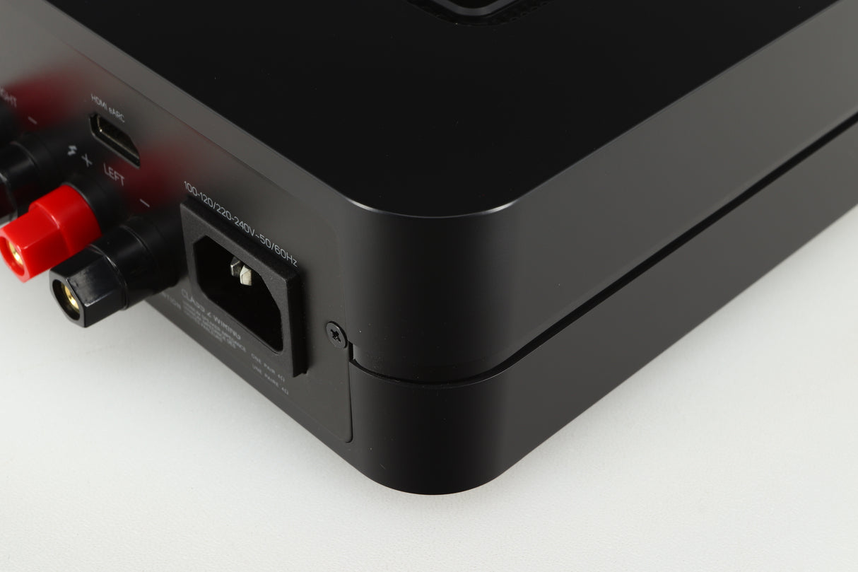 Rear left corner of a used Bluesound Power Node Streamer in a black finish