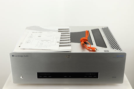Top of a used Cambridge Audio 851W Power Amplifier in a silver finish showing Manual and Interconnect Cable