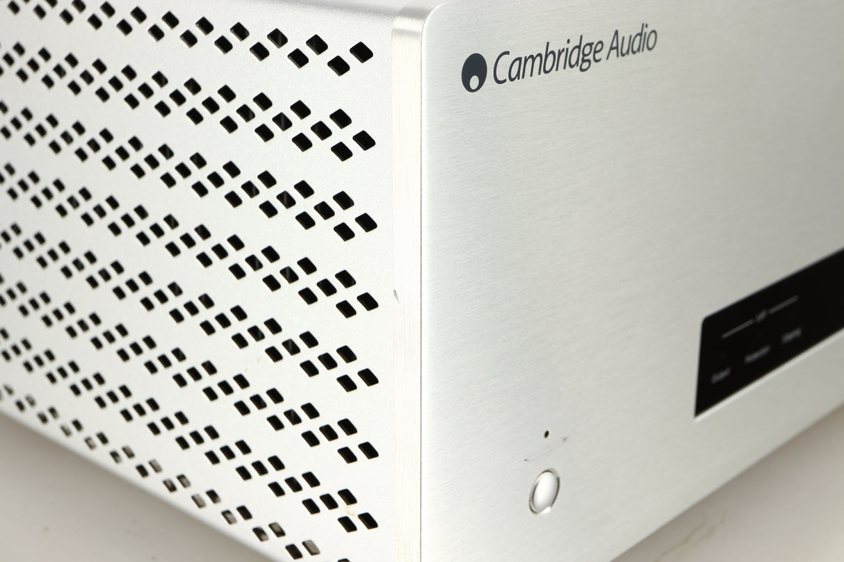 Close up of a used Cambridge Audio 851W Power Amplifier in a silver finish showing small nick on front left corner