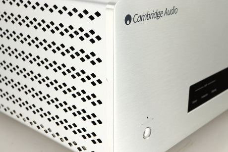 Close up of a used Cambridge Audio 851W Power Amplifier in a silver finish showing small nick on front left corner