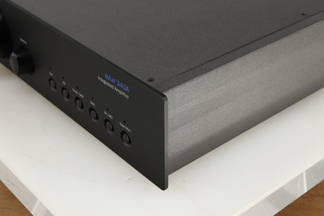 Front right corner of a used Cambridge Audio 340A Integrated Amplifier in a black finish