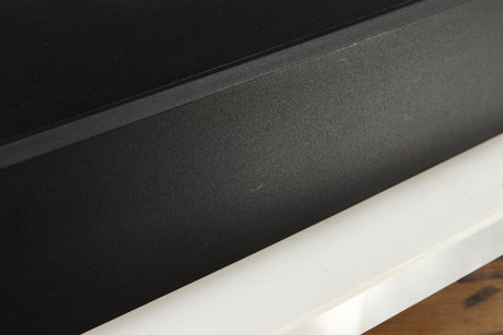 Close up of a used Cambridge Audio CD2 CD Player in a black finish showing scratches on right side