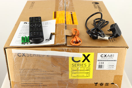 Box for a used Cambridge Audio CXA81 Series 2 Integrated Amplifier in a lunar grey finish showing Remote, 3x Batteries, Bluetooth Antenna, Manual, Interconnect Cable and Mains Cable