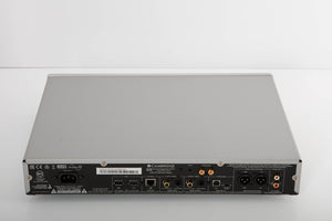 Rear view of a used Cambridge Audio CXN V2 Streamer in a silver finish showing Mains Input, Phono Inputs, Phono Outputs, USB Inputs, Optical Input, Optical Output, Network Input and XLR Output