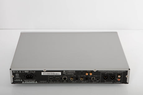 Rear view of a used Cambridge Audio CXN V2 Streamer in a silver finish showing Mains Input, Phono Inputs, Phono Outputs, USB Inputs, Optical Input, Optical Output, Network Input and XLR Output