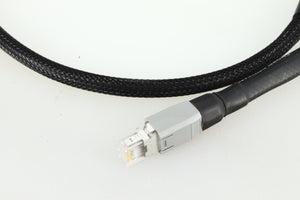 Close up of a used Chord Company Signature Super Aray Digital Streaming Cable 1.0m in a black finish showing the connector