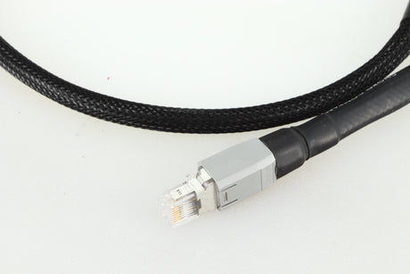Close up of a used Chord Company Signature Super Aray Digital Streaming Cable 1.0m in a black finish showing the connector