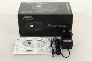 Box of a used Chord Electronics 2Qute DAC in Black finish with mains cable, manual, and USB cable 