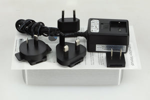 Top view of a used Chord Electronics 2Qute Digital Analogue Converter in a silver finish showing a power supply, mains plug, manual and 3x schuko plugs