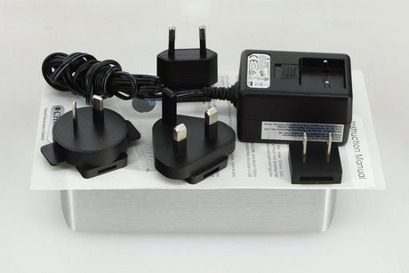 Top view of a used Chord Electronics 2Qute Digital Analogue Converter in a silver finish showing a power supply, mains plug, manual and 3x schuko plugs