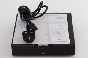 Top of a used Chord Electronics Bertti Power Amplifier in a Black finish showing Manual and Mains Cable