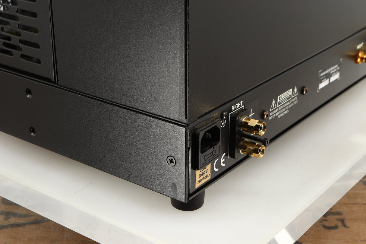 Close up of a used Conrad Johnson MV60SE Power Amplifier showing mark on rear right corner
