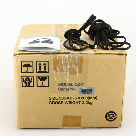 Box for used Crosszone CZ-1 Headphones in a black / gold finish showing Manual, Warranty Card and Headphone Cables
