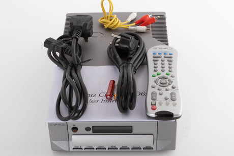 Top of a used Cyrus CD8X CD Player in a Quartz Silver finish showing Manual, Remote, Batteries, Mains Cable, Schuko Cable and Interconnect Cable