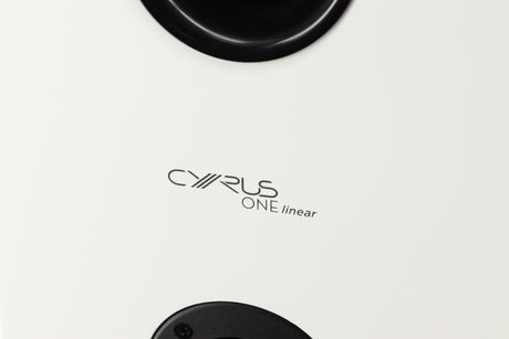 Close up of a used Cyrus ONE Linear Standmount Speaker in a gloss white finish showing logo