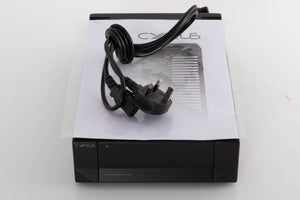 Top of a used Cyrus PSX-R2 Power Supply in a Brushed Black finish showing Mains Cable and Manual