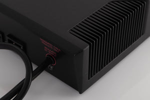 Rear left corner of a used Cyrus PSX-R2 Power Supply in a Brushed Black finish