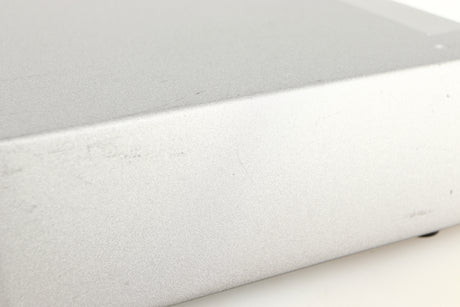 Close up of a used Cyrus Q-Power Power Amplifier in a silver finish showing scratching on unit