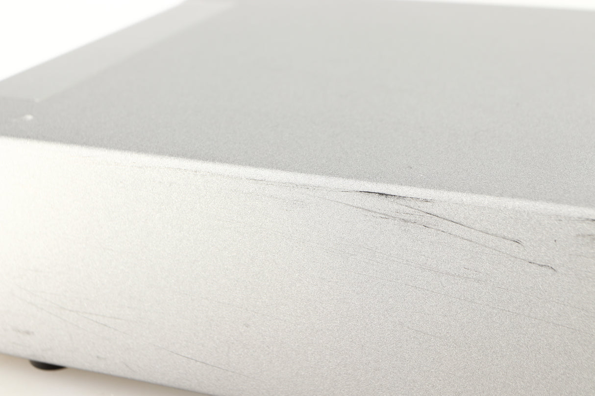 Close up of a used Cyrus Q-Power Power Amplifier in a silver finish showing scratching on unit