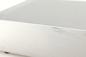 Close up of a used Cyrus Q-Power Power Amplifier in a silver finish showing scratching on unit