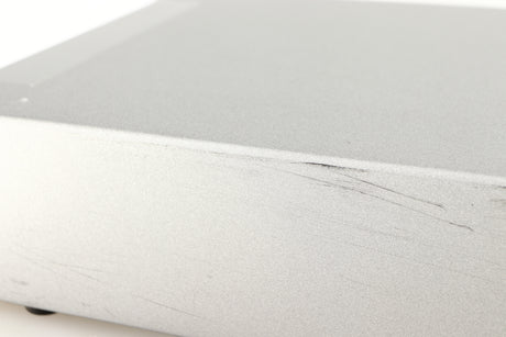 Close up of a used Cyrus Q-Power Power Amplifier in a silver finish showing scratching on unit