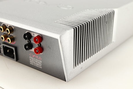 Rear left corner of a used Cyrus Q-Power Power Amplifier in a silver finish