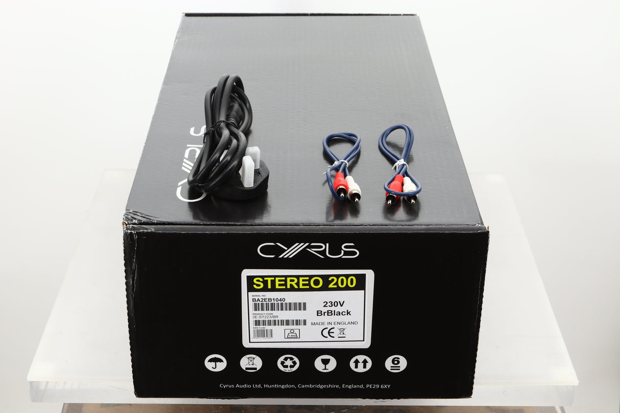 Box of a used Cyrus Stereo 200 Power Amplifier in BrBlack finish showing mains cable and MC-Bus cables