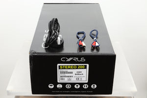 Box of a used Cyrus Stereo 200 Power Amplifier in BrBlack finish showing mains cable and MC-Bus cables