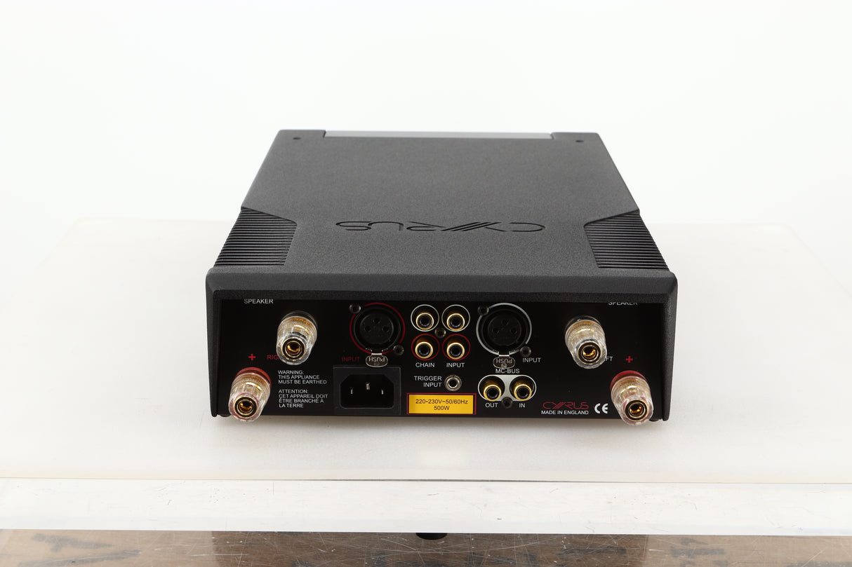 Rear view of a used Cyrus Stereo 200 Power Amplifier in BrBlack finish showing speaker outputs, MC-Bus, mains, and XLR input