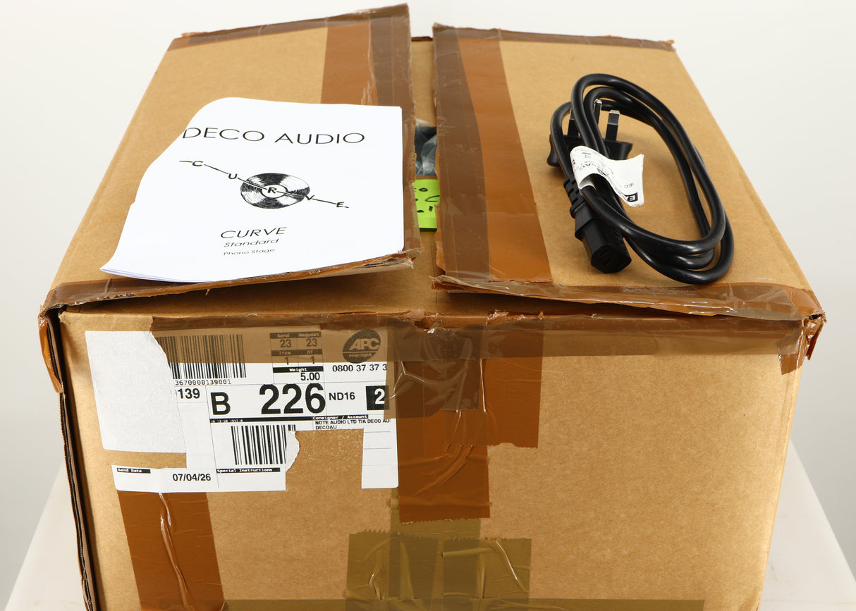 Box for a used Deco Audio Curve MM Phonostage in a black finish showing Mains Cable and Manual