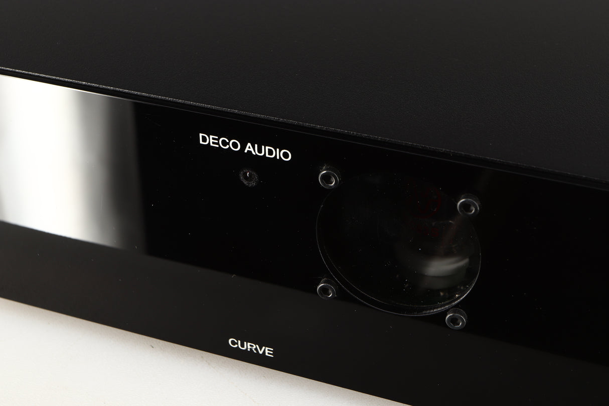 Close up of a used Deco Audio Curve MM Phonostage in a black finish showing light scratches on fascia and fingerprints inside of glass