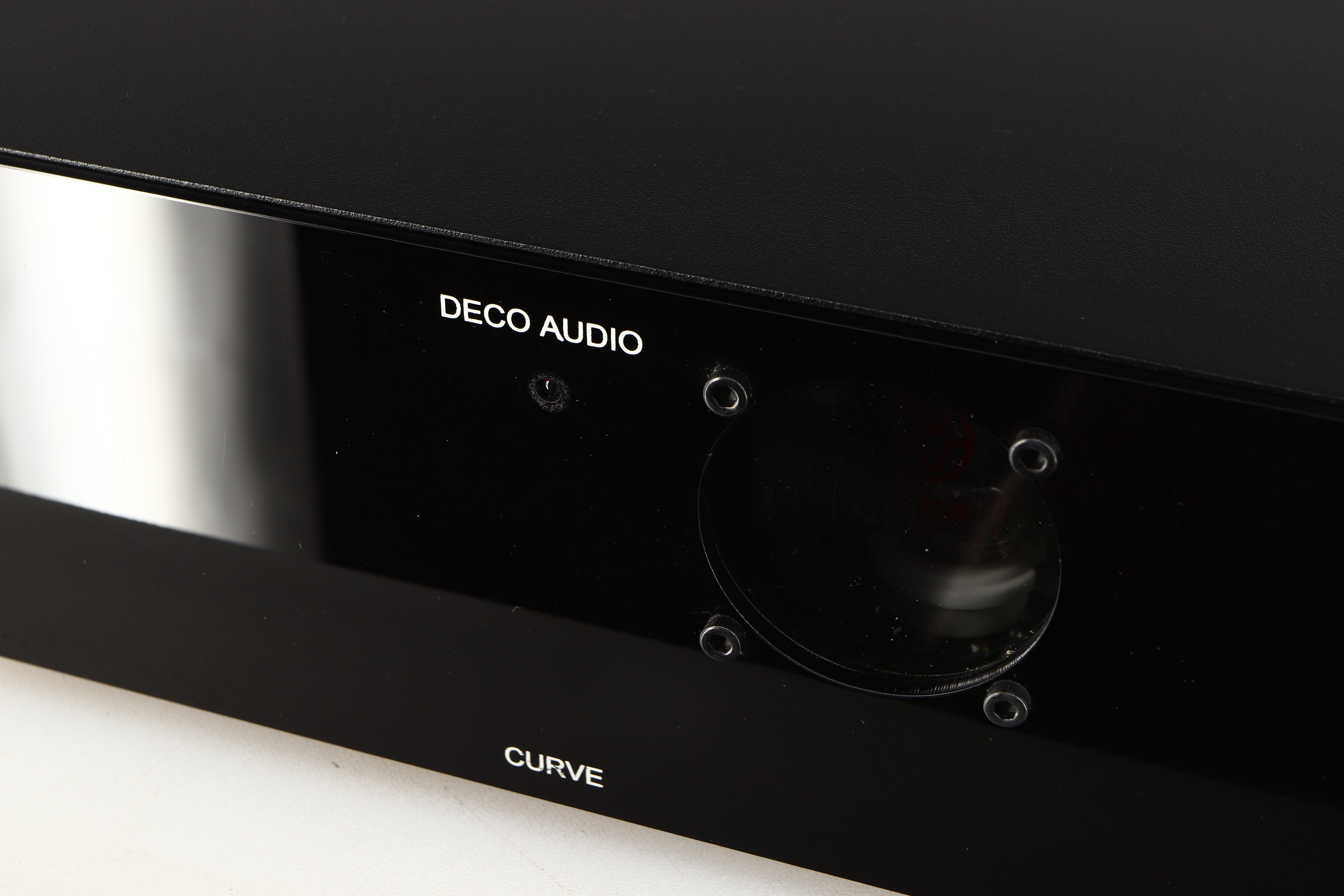 Close up of a used Deco Audio Curve MM Phonostage in a black finish showing light scratches on fascia and fingerprints inside of glass