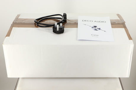 Box of a used Deco Audio Curve Standard Phonostage showing mains cable and manual