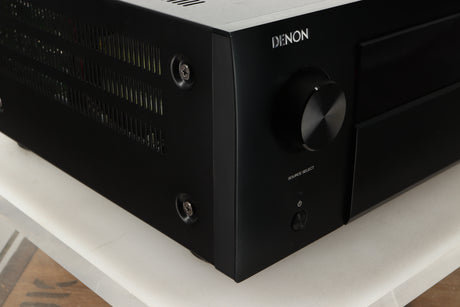 Front left corner view of a used Denon AVR-4700 AV Amplifier in Black finish