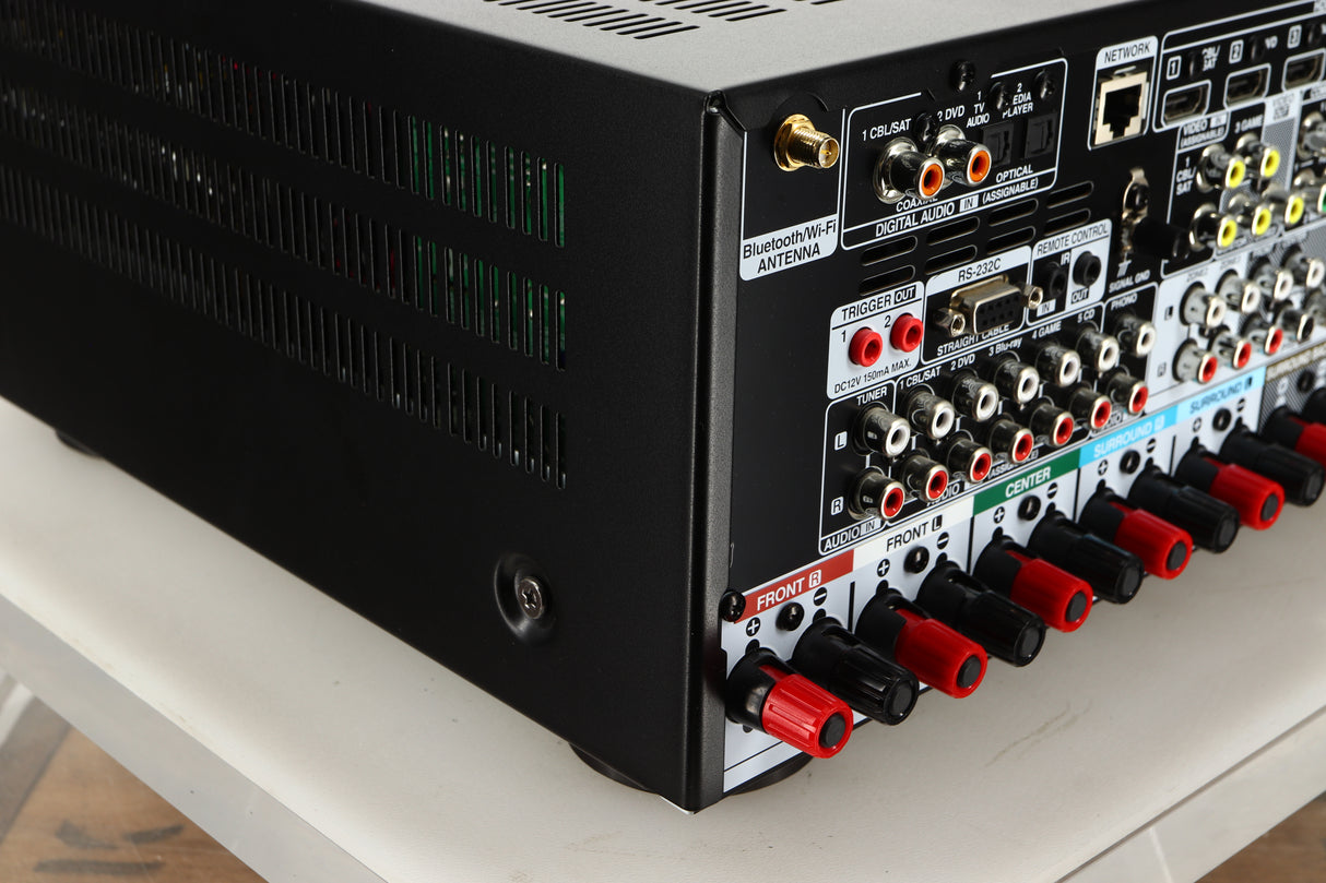 Rear left corner view of a used Denon AVR-4700 AV Amplifier in Black finish