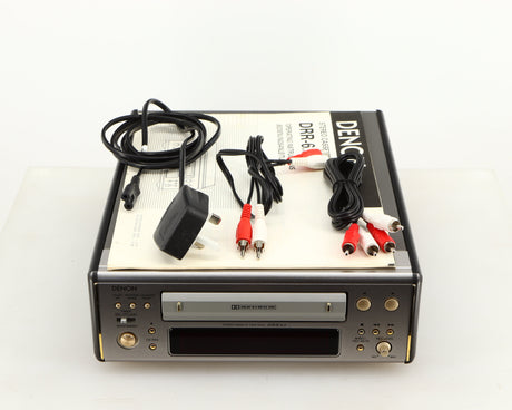 Top of a used Denon DDR-6.5 Cassette Deck in a silver finish showing Manual, 2x Interconnect Cables and Power Cable