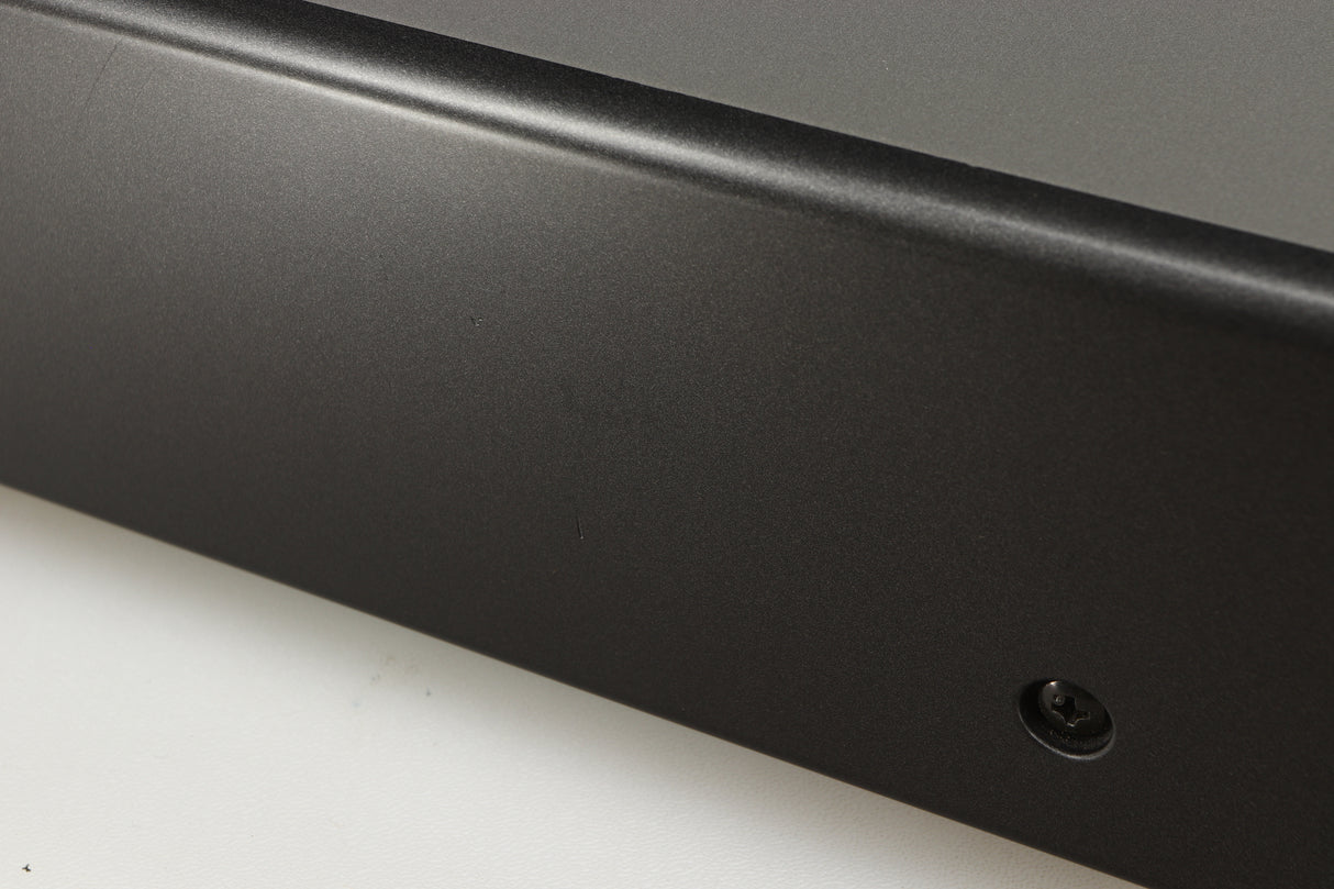 Close up of a used Denon DDR-6.5 Cassette Deck in a silver finish showing some scratches on left side