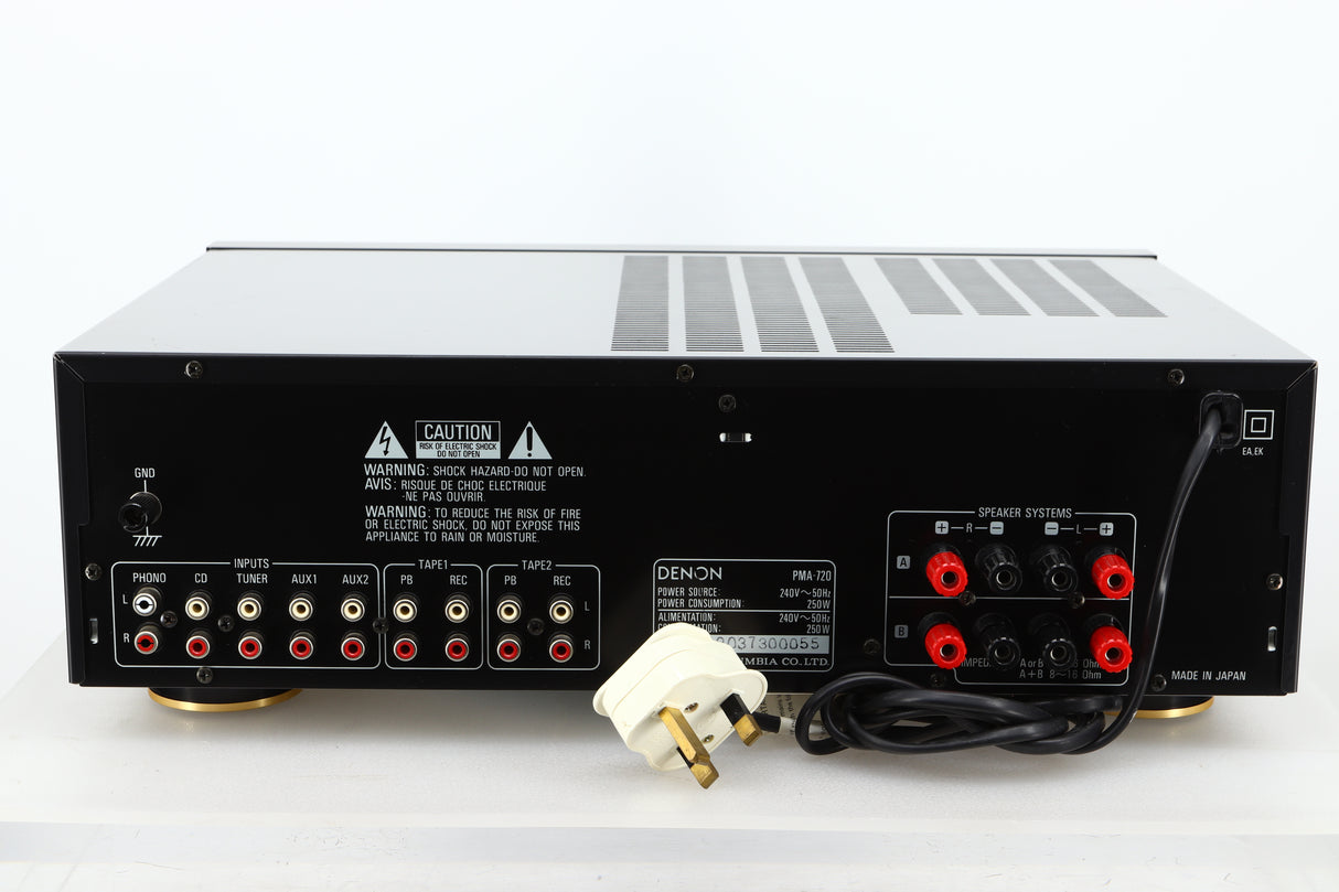Rear view of a used Denon PMA-720 Integrated Amplifier in Black finish showing RCA inputs, and speaker outputs 