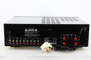 Rear view of a used Denon PMA-720 Integrated Amplifier in Black finish showing RCA inputs, and speaker outputs 