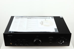Top view of a used Denon PMA600 Integrated Amplifier in a black finish showing manual