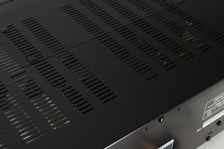 Close up of a used Denon PMA600 Integrated Amplifier in a black finish showing some light scratching on top