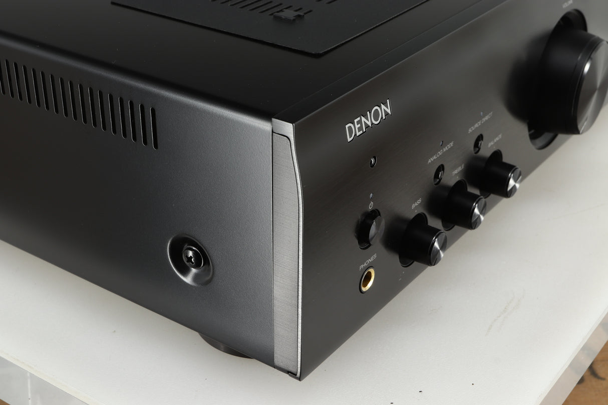 Front left corner of a used Denon PMA600 Integrated Amplifier in a black finish