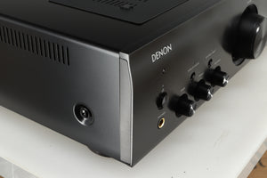 Front left corner of a used Denon PMA600 Integrated Amplifier in a black finish
