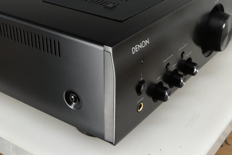 Front left corner of a used Denon PMA600 Integrated Amplifier in a black finish