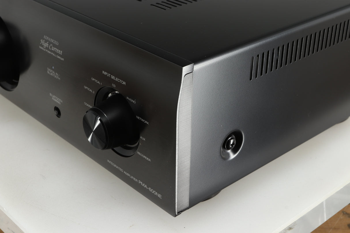 Front right corner of a used Denon PMA600 Integrated Amplifier in a black finish