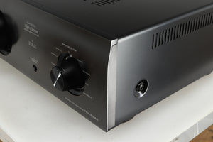 Front right corner of a used Denon PMA600 Integrated Amplifier in a black finish
