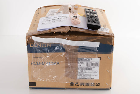 Box of a used Denon RCD M41DAB Music System in Black with aerial, remote, and manual 