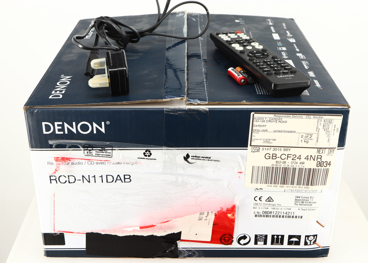 Box for a used Denon RCD-N10 Network CD Receiver in a black finish showing Remote, 2x Batteries and Power Cable