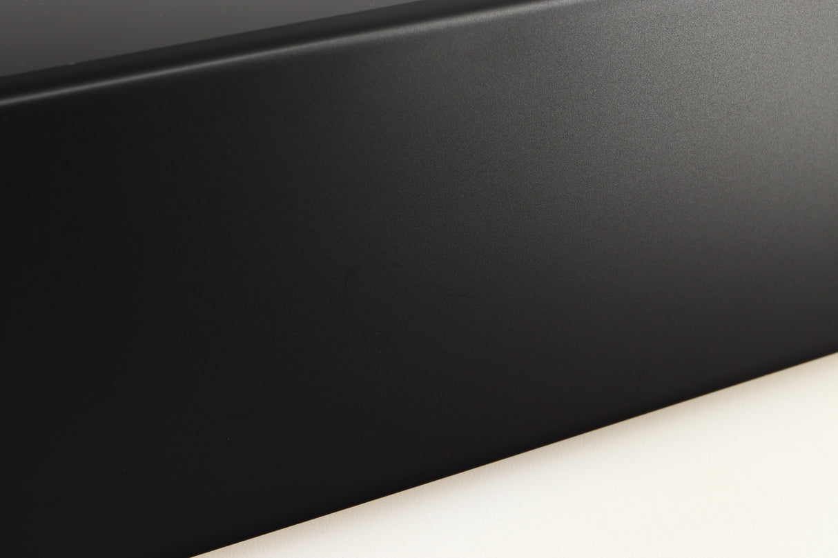 Close up of a used Denon RCD-N10 Network CD Receiver in a black finish showing light scratches on left side